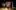 2018_LAIT_I Am England_SevenArts_Photo_MSpadafora Eight young adults stand in a group facing forwards under stage lighting, in front of a Union Jack flag