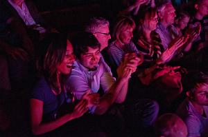 A row of audience members clapping.