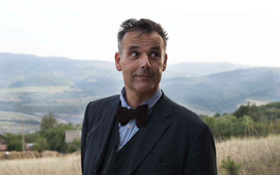 RobNewmanStandard Comedian Rob Newman wearing a bow tie in the countryside