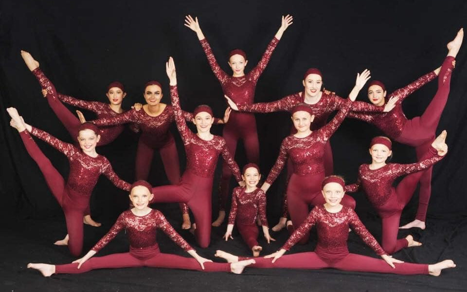 Elev8dance Dancers Elev8dance Dancers all in red jumpsuits