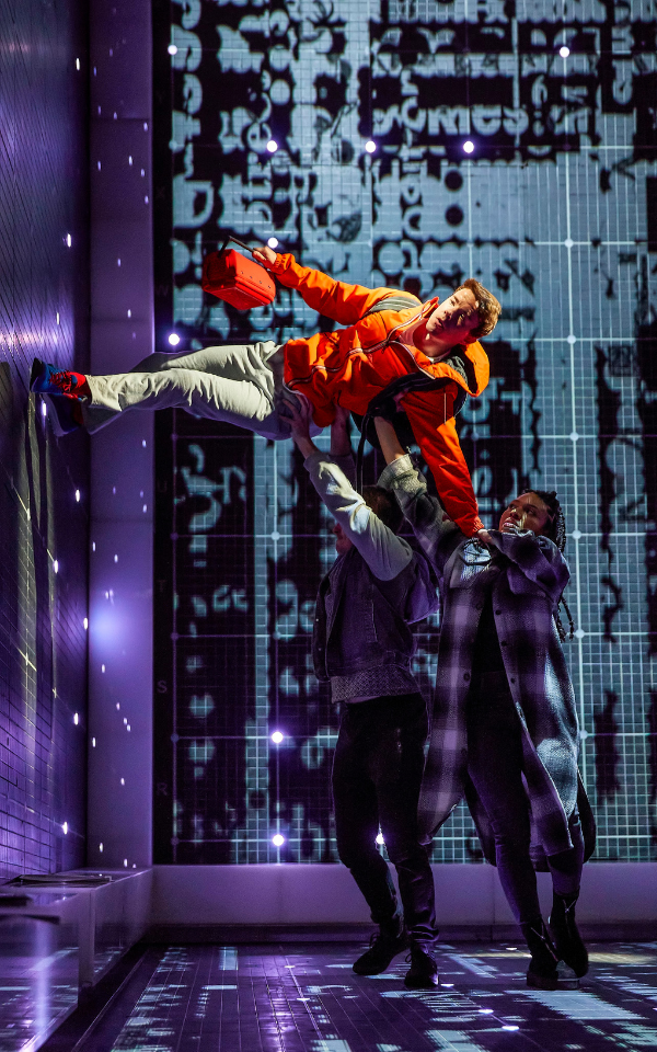 David Breeds in The Curious Incident of the Dog in the Night-Time David Breeds supported by two company members walks across a wall