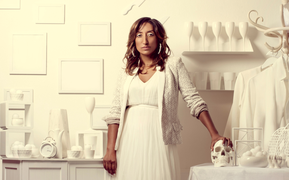 Shazia Mirza Shazia Mirza in a white dress against a white background and surrounded by various white things