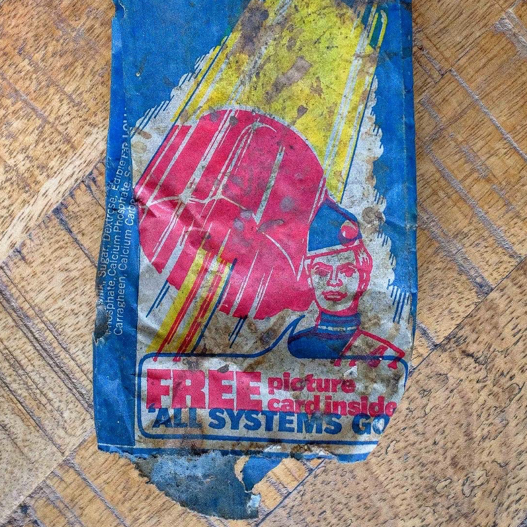 Zoom lollipop Old blue, yellow and pink packaging for a Zoom lolly with the words 'Free picture card inside: All systems go'