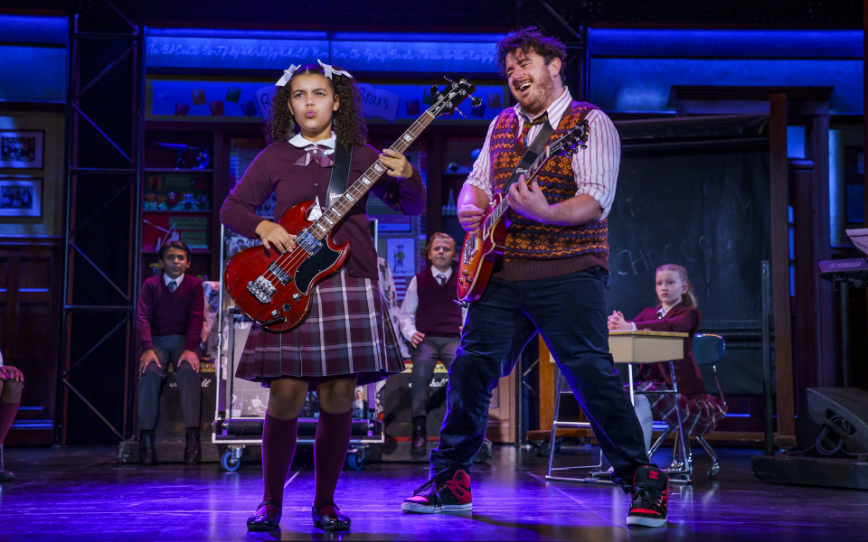 School of Rock A child actor playing bass alongside Jake Sharp as Dewey Finn playing guitar