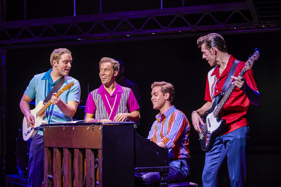Credit Brinkhoff-Moegenburg Four men around a piano. One plays it and two play guitar