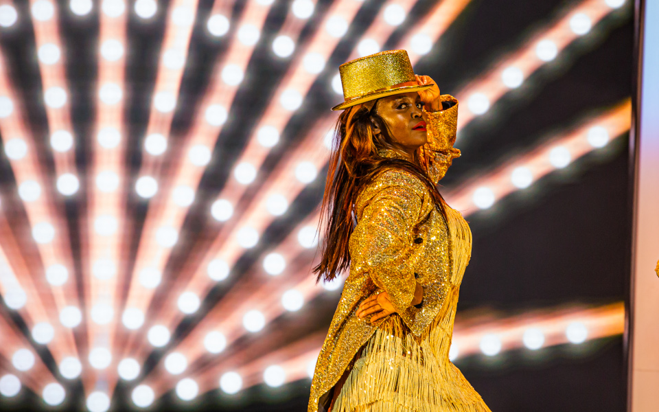 Oti Mabuse I Am Here Oti Mabuse in a gold jacket and top hat