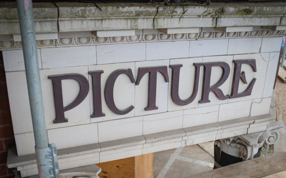 HPPH Facade Tiles CLose up of facade tiles reading 'picture' with scaffolding
