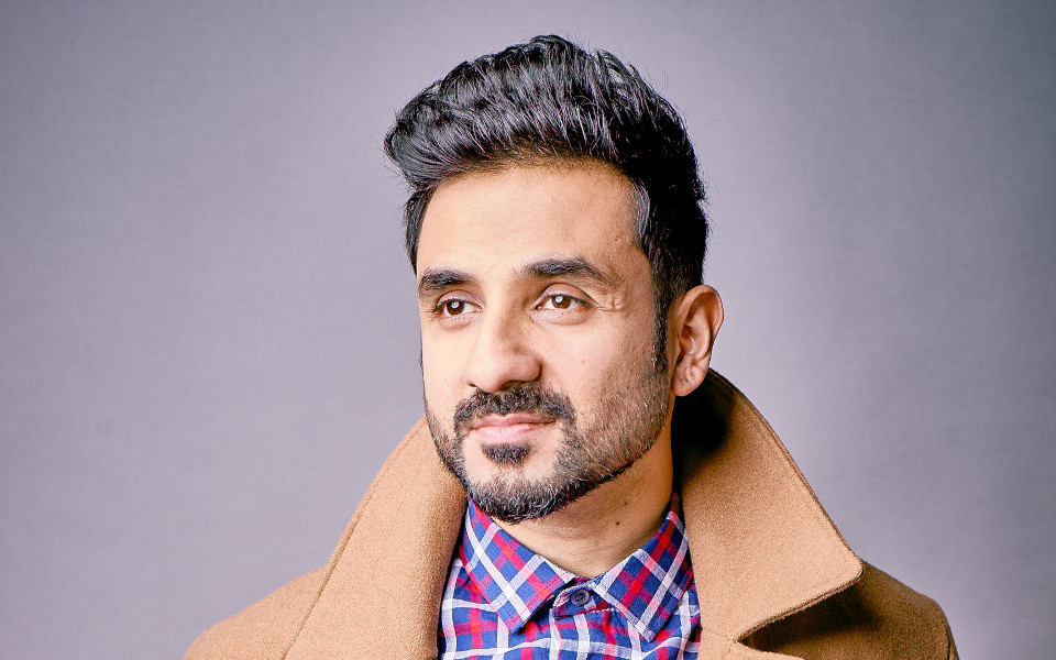 Vir Das Vir Das wearing a brown trench coat with upturned collar and checked shirt